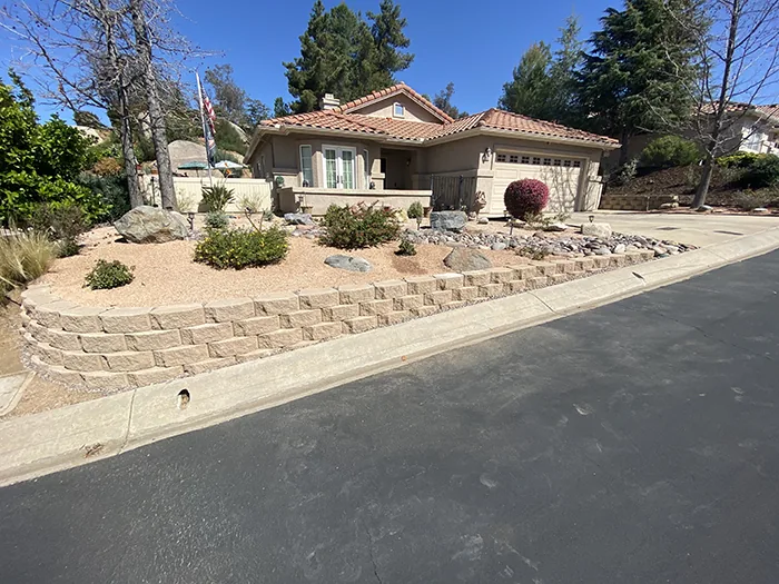Engineered interlocking segmental retaining wall stabilizing terraced yard