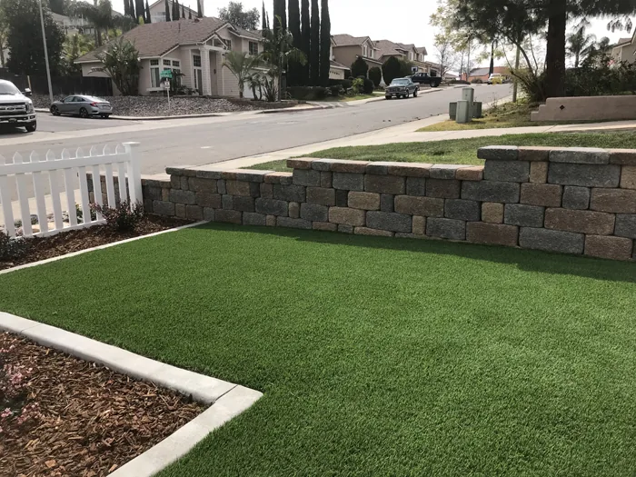 Continuous concrete curbing framing residential flowerbed in Santee CA